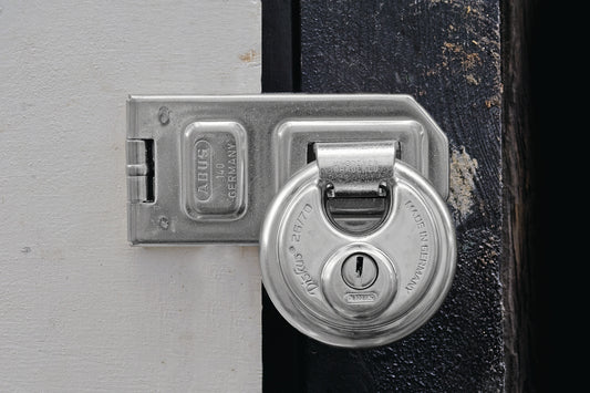 Abus Diskus padlock attached to Abus Hasp & Staple on a gate