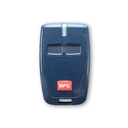 Dark blue garage & gate remote with 2 buttons & red & white BFT raised logo at the bottom front of the remote