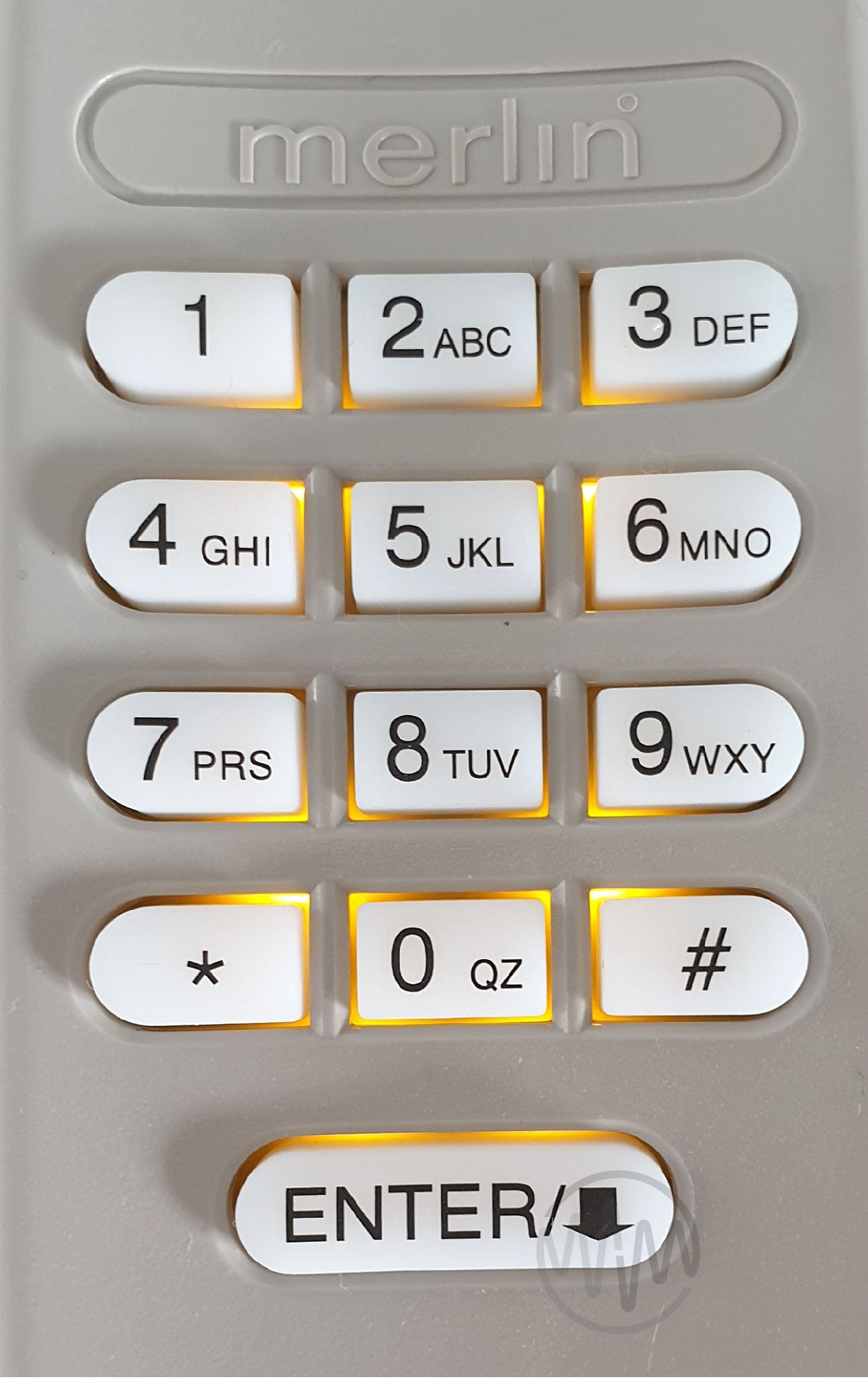 Close up of Merlin E840M garage door & gate keypad with yellow backlight behind buttons