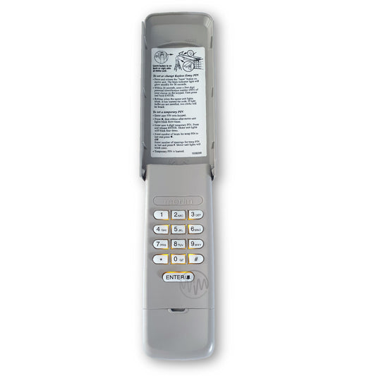 Merlin E840M beige plastic garage gate keypad with cover open showing buttons lit up yellow