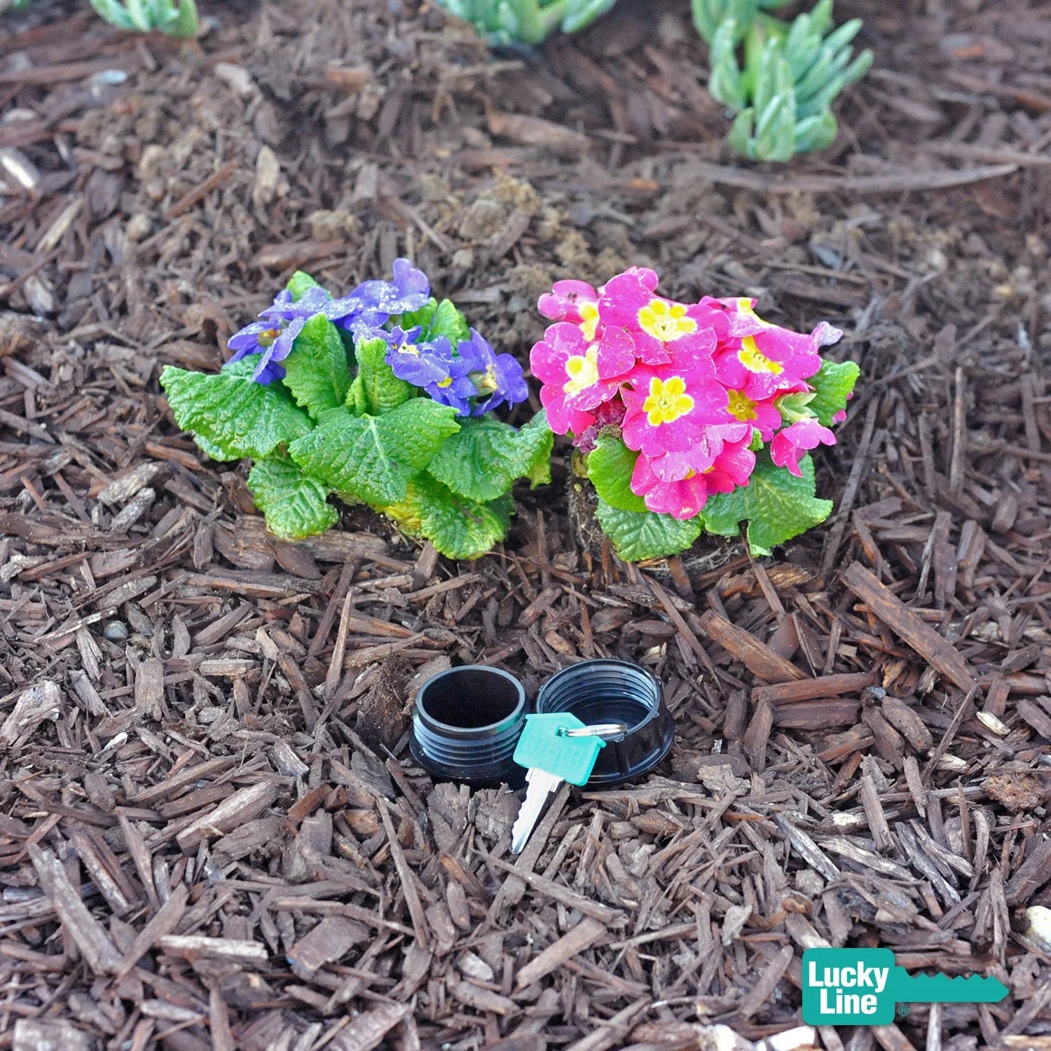 Lucky Line faux sprinkler shown embedded in a bark garden with top off 