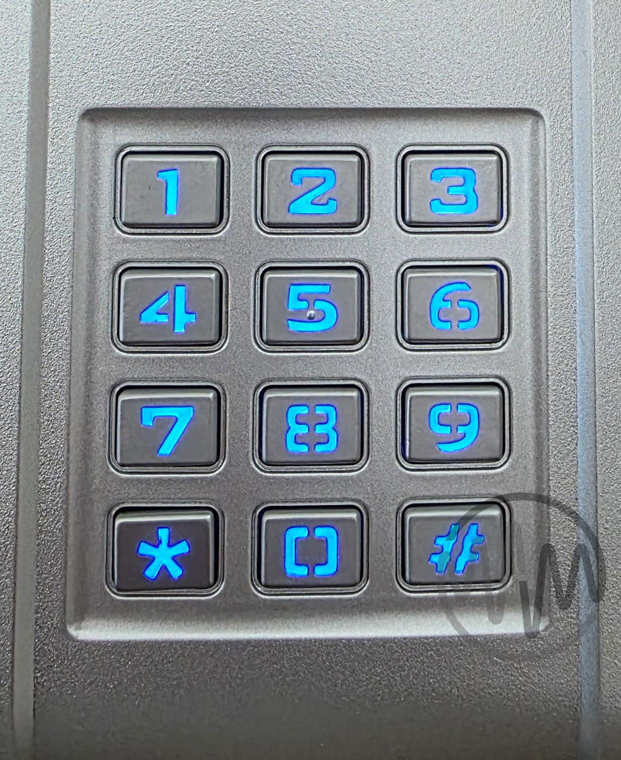 Close up View of Silver Merlin brand garage door keypad with blue backlit digits