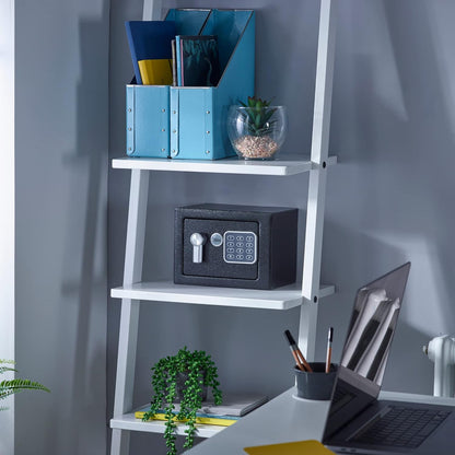 Yale black mini safe with digital key pad sitting on a white ladder bookshelf